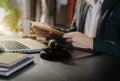 Lawyer signing important legal document on desk at office Royalty Free Stock Photo