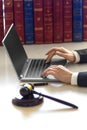 Lawyer woman`s hands with judicial gavel during online consultation with client.