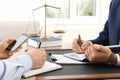 Lawyer working with client at table in office, focus Royalty Free Stock Photo