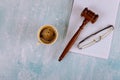 Lawyers Judge desk with wooden judges gavel a cup of coffee, notebook of reading glasses Royalty Free Stock Photo