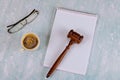 Lawyers Judge desk with wooden judges gavel a cup of coffee, notebook of reading glasses Royalty Free Stock Photo