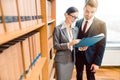 Lawyers in library of law firm discussing strategy in a case holding file Royalty Free Stock Photo