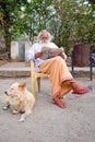 LAXMAN JHULA, INDIA - APRIL 20, 2017: A Hindu swami sitting reading a news paper in Laxman Jhula India