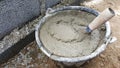 Lay bricks with cement mixing tub, mortar concrete Royalty Free Stock Photo