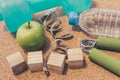 Lay Flat - Dumbbell, Fresh Apple, Measuring Tape, Mineral Water, Hand grip & Blank Wooden Cubes, customizable for New Year. Royalty Free Stock Photo