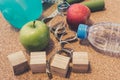 Lay Flat - Dumbbell, Fresh Apple, Measuring Tape, Mineral Water, Hand grip & Blank Wooden Cubes, customizable for New Year. Royalty Free Stock Photo