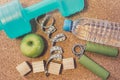 Lay Flat - Dumbbell, Fresh Apple, Measuring Tape, Mineral Water, Hand grip & Blank Wooden Cubes, customizable for New Year. Royalty Free Stock Photo