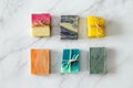 Lay flat top view of three ecologic handmade soap bars. White marble background