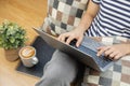 Lay flat view of asian woman working at home with laptop and black coffee on wooden floor shows concept of working from anyway by Royalty Free Stock Photo