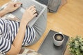 Lay flat view of asian woman working at home with laptop and black coffee on wooden floor shows concept of working from anyway by Royalty Free Stock Photo