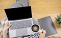 Lay flat view of asian woman working at home with laptop, pillow and latte coffee on wooden floor shows concept of working from Royalty Free Stock Photo