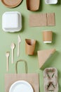 Lay flat view of eco-friendly disposable utensils on a green background