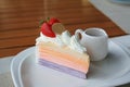 Layer cake slice topped with fresh strawberries and chocolate coin on white plate Royalty Free Stock Photo