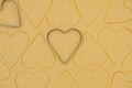 Layer of shortbread dough with cut hearts for Valentine`s Day. Valentine`s Day food background. Top view Royalty Free Stock Photo