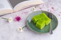 Layer sweet cake on a plate and a cup of white coffee with a book on gray stone background Royalty Free Stock Photo