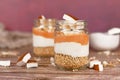 Layered breakfast or dessert with puffed quinoa grains, yogurt and coconut flakes and pieces