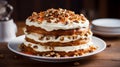 A layered carrot cake with cream cheese frosting and chopped nuts on top Royalty Free Stock Photo