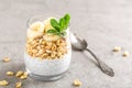 Layered chia pudding parfait with banana, sweet wheat with honey and yogurt