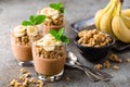 Layered chocolate chia pudding parfait with banana, granola and yogurt, dessert Royalty Free Stock Photo