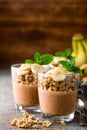 Layered chocolate chia pudding parfait with banana, granola and yogurt, dessert Royalty Free Stock Photo