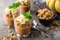 Layered chocolate chia pudding parfait with banana, granola and yogurt, dessert Royalty Free Stock Photo