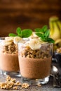 Layered chocolate chia pudding parfait with banana, granola and yogurt, dessert Royalty Free Stock Photo