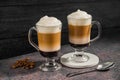 Layered coffee latte drinks. Hot coffee drinks in glass mugs, dark background Royalty Free Stock Photo