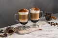 Layered coffee latte drinks. Hot coffee drinks in glass mugs, dark background Royalty Free Stock Photo