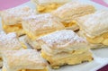 Layered cream pie with powdered sugar