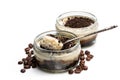 Layered creamy cappuccino cheesecakes in glass jars on white