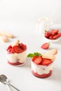 Layered dessert in glass jars with cookies, mascarpone cheese and whipped cream.