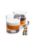 Layered dessert in glass with orange jelly with vanilla and chocolate mousse isolated on white Royalty Free Stock Photo