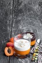 Layered dessert in glass with orange jelly with vanilla and chocolate mousse on rustic wooden table Royalty Free Stock Photo