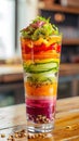 Layered fruit salad in a clear glass, vibrant and healthy.- AI Generated