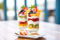 layered fruit salad parfait in clear glasses