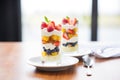 layered fruit salad parfait in clear glasses