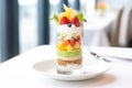 layered fruit salad parfait in clear glasses