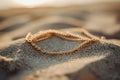 Layered golden anklet glistening on beach sand at sunset