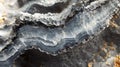 Layered grey and black mineral specimen showing banded texture Royalty Free Stock Photo