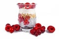 Layered healthy breakfast in glass with chia seed pudding, puffed quinoa grains and joghurt topped with red raspberry and cranberr Royalty Free Stock Photo