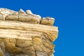 Layered limestone cliff against blue sky