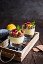 Layered mango dessert with cream cheese, crushed biscuits and freeze dried raspberriesLayered mango dessert with cream cheese, cru Royalty Free Stock Photo