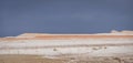 Layered multi-colored hills and slopes with relief from water and wind