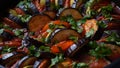 Layered ratatouille in a baking dish, slices of zucchini, red bell pepper, chili, yellow squash, eggplant, olive oil, parsley and