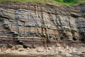 layered rock patterns in a sedimentary cliff