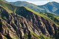 layered rocks in a steep mountain valley