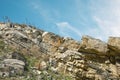 Layered rocks with vibrant blue sky