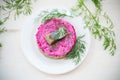 layered salad of boiled vegetables with beets and herring on a plate Royalty Free Stock Photo