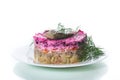 layered salad of boiled vegetables with beets and herring on a plate Royalty Free Stock Photo