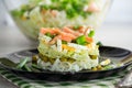 Layered salad of cabbage and other vegetables with pieces of red fish in a plate. Royalty Free Stock Photo